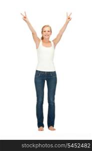 happy teenage girl in blank white t-shirt showing victory sign