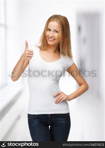 happy teenage girl in blank white t-shirt with thumbs up