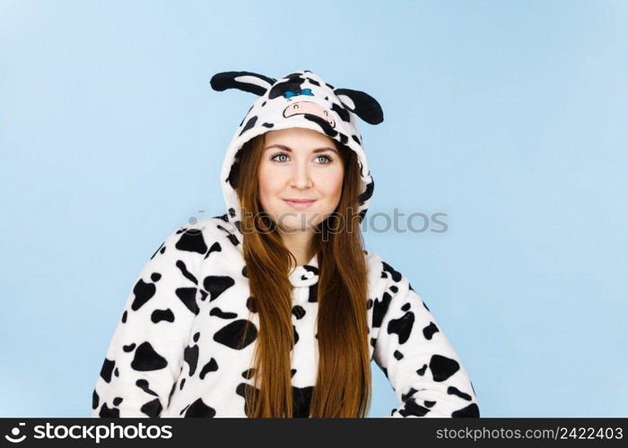 Happy teenage girl in funny nightclothes, pajamas cartoon style smiling, positive face expression, studio shot on blue.. Woman wearing pajamas cartoon smiling