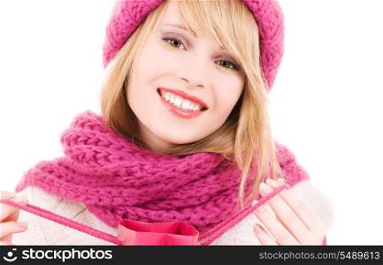 happy teenage girl in hat with pink shopping bag