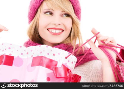 happy teenage girl in hat with pink shopping bags