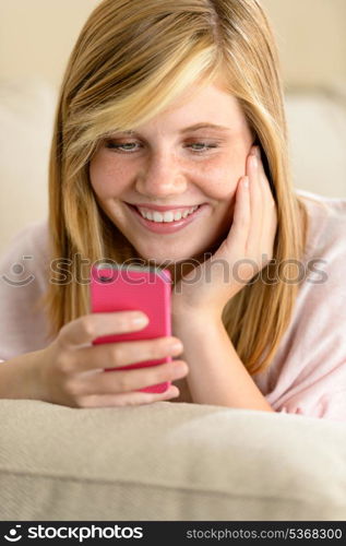 Happy teenage girl in love receive SMS on her cellphone