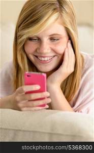 Happy teenage girl in love receive SMS on her cellphone