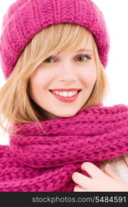 happy teenage girl in winter hat over white