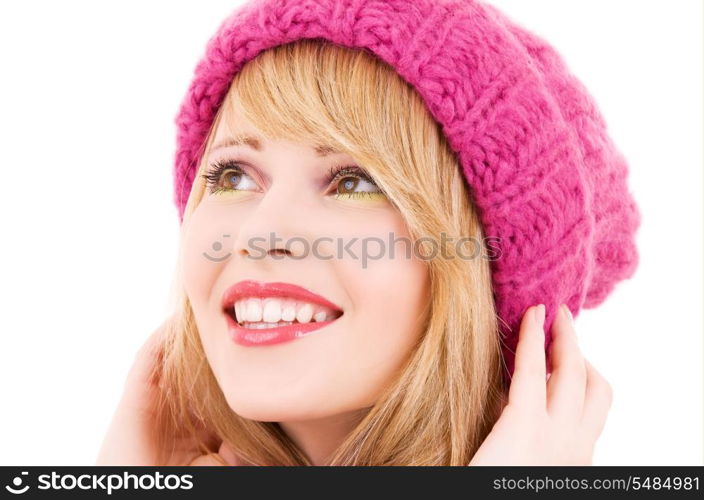 happy teenage girl in winter hat over white