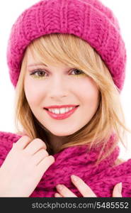 happy teenage girl in winter hat over white