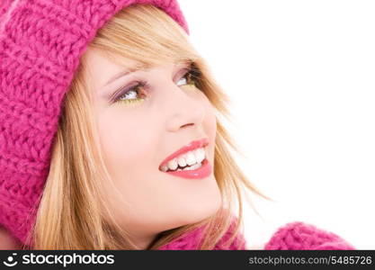 happy teenage girl in winter hat over white