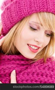 happy teenage girl in winter hat over white