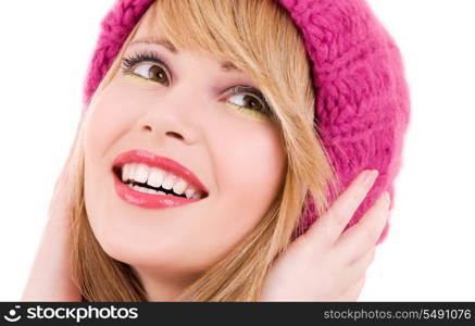 happy teenage girl in winter hat over white