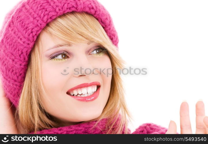 happy teenage girl in winter hat over white