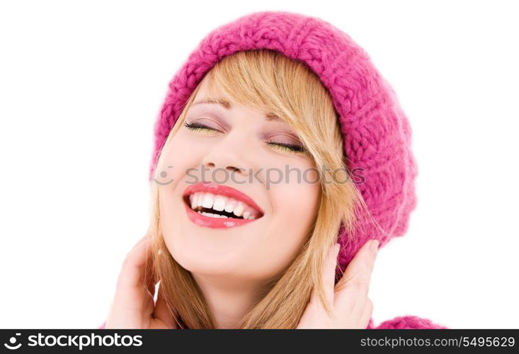 happy teenage girl in winter hat over white