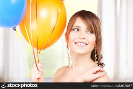 happy teenage girl with balloons at home