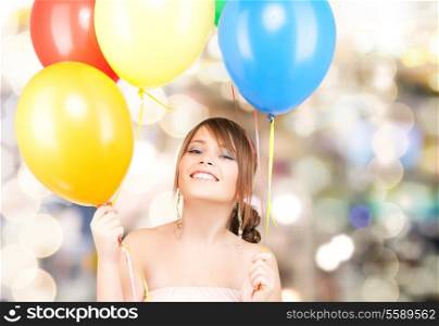 happy teenage girl with balloons over white