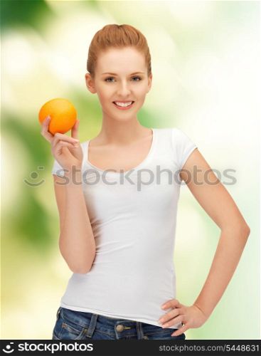 happy teenage girl with orange over green