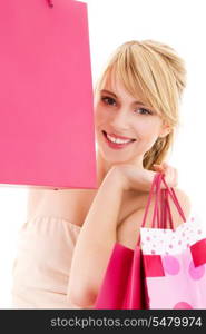 happy teenage girl with pink shopping bags