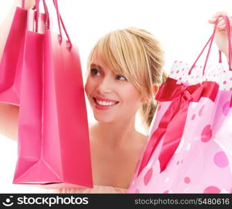 happy teenage girl with pink shopping bags