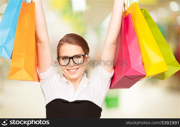 happy teenage girl with shopping bags at the mall