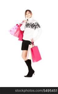 happy teenage girl with shopping bags over white&#xA;
