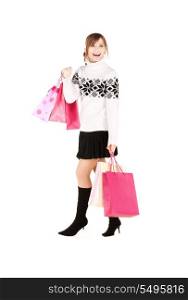 happy teenage girl with shopping bags over white&#xA;