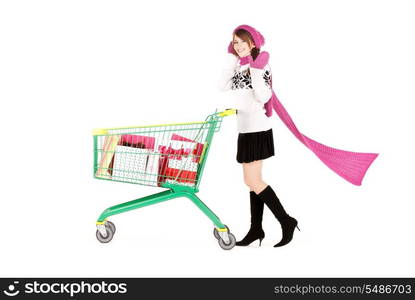 happy teenage girl with shopping cart over white