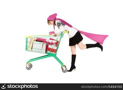 happy teenage girl with shopping cart over white