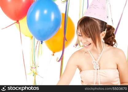 happy teenage party girl with balloons over white