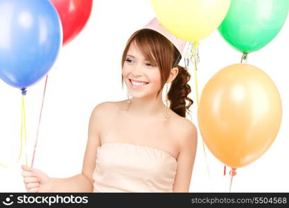 happy teenage party girl with balloons over white