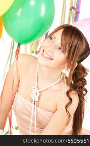 happy teenage party girl with balloons over white