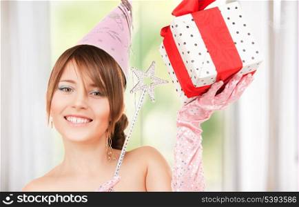 happy teenage party girl with magic wand and gift box