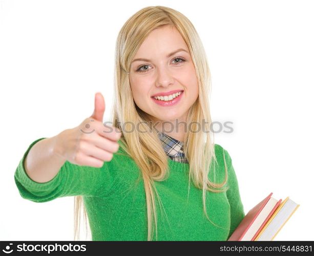 Happy teenage student girl showing thumbs up