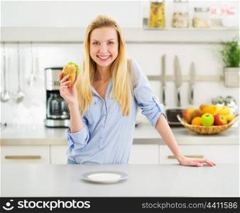 Happy teenager girl holding burger