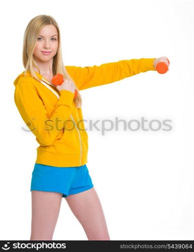 Happy teenager girl making exercise with dumbbells