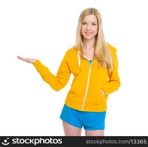 Happy teenager girl presenting something on empty palm