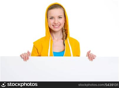 Happy teenager girl showing blank billboard
