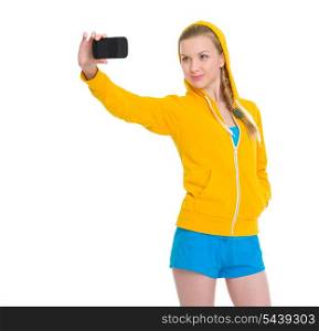 Happy teenager girl taking photo with cell phone