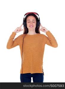 Happy teenager girl with headphones listening music isolated on a white background