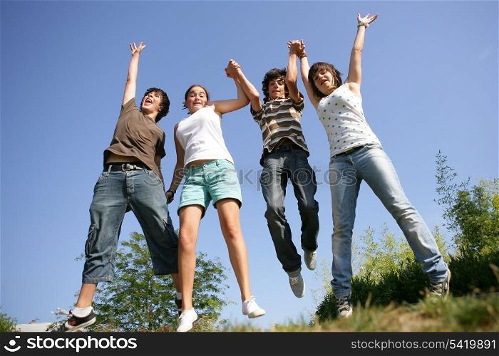 Happy teenagers jumping in air