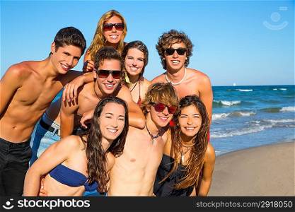 Happy teenagers young group together on beach in summer vacations