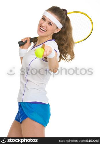 Happy tennis player with racket and ball pointing in camera