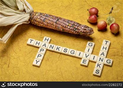 Happy Thanksgiving and give thanks crossword with ornamental corn and crab apples, fall holiday celebration