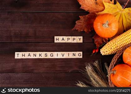 Happy Thanksgiving Day. Ripe orange pumpkins, wheat and corn on a brown wooden background.. Happy Thanksgiving Day. Ripe orange pumpkins, wheat and corn on brown wooden background.