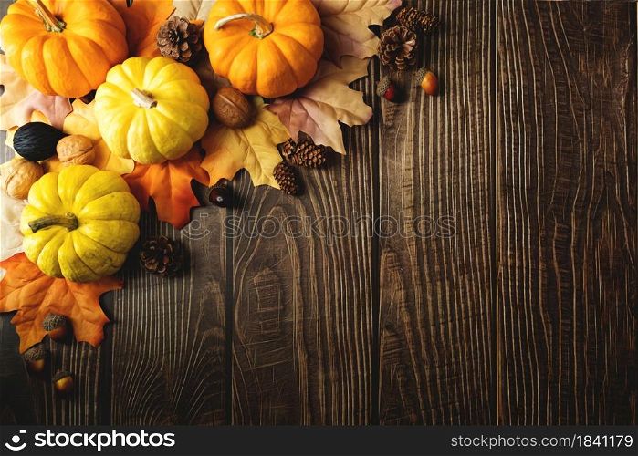 Happy Thanksgiving Day with pumpkin and nut on wooden table