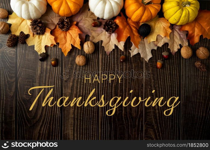 Happy Thanksgiving Day with pumpkin and nut on wooden table