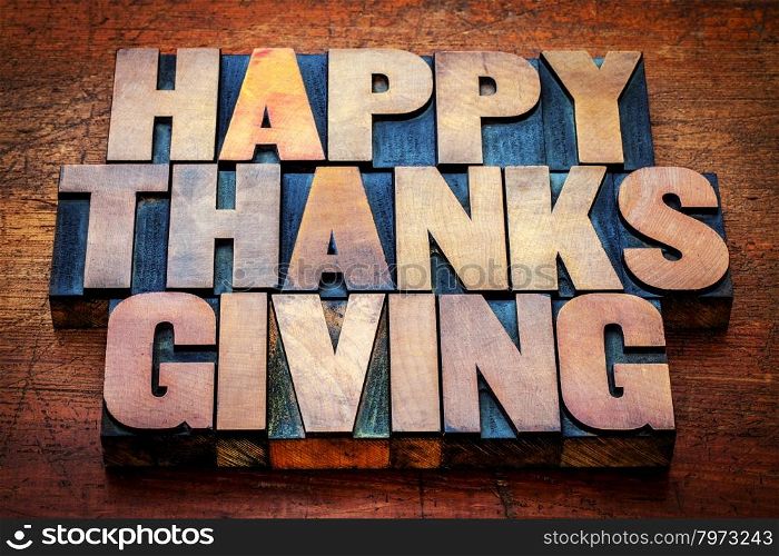 Happy Thanksgiving greetings card or sign - text in vintage letterpress wood type blocks stained by color inks