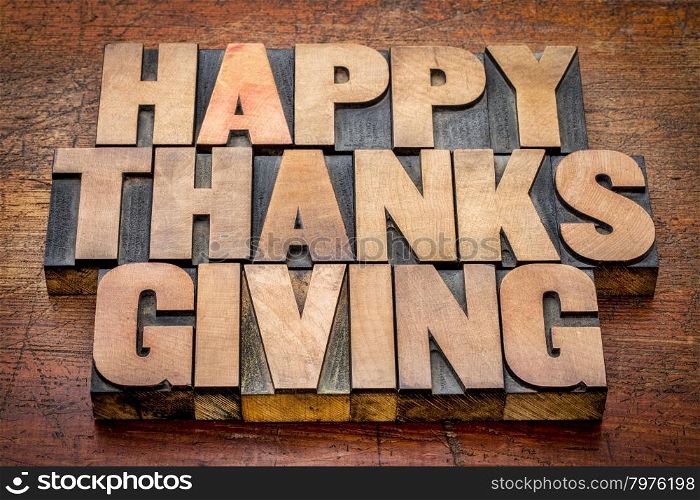 Happy Thanksgiving greetings card or sign - text in vintage letterpress wood type blocks against rustic wood