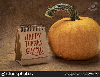 Happy Thanksgiving - handwriting in a desktop calendar with a pumpkin, fall holiday greetings