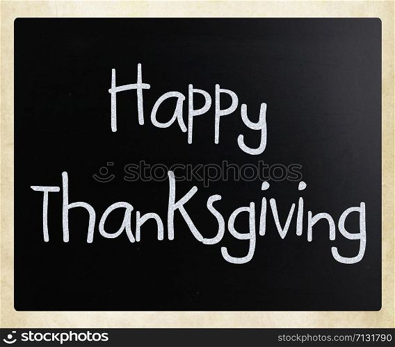 ""Happy Thanksgiving" handwritten with white chalk on a blackboard"
