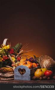 Happy Thanksgiving still life. Fruits, nuts and vegetables, fall crop on the table. Copy space