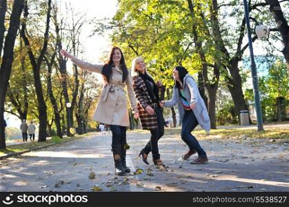 Happy three friends having fun outdoors in nature