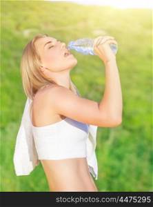 Happy tired woman drink water after workout in the park, enjoying training outdoors in sunny day, sportive and healthy lifestyle&#xA;